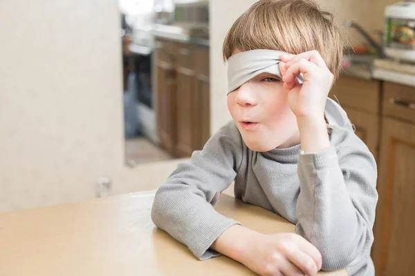 El niño tenía los ojos vendados en casa. — Foto de Stock