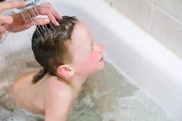 Little child is washing her hair in bath — Stock Photo, Image