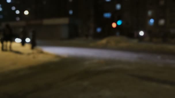 Blurred background. Night city lights blur cars, road, people in winter. — Stock Video