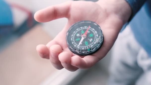 Child holds the compass in his hand. — Stock Video