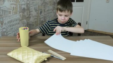 7 yaş çocuk çizmek için gidiyor: bir yaprak kağıda dökülen masaya alır hissettim kalemler cam.