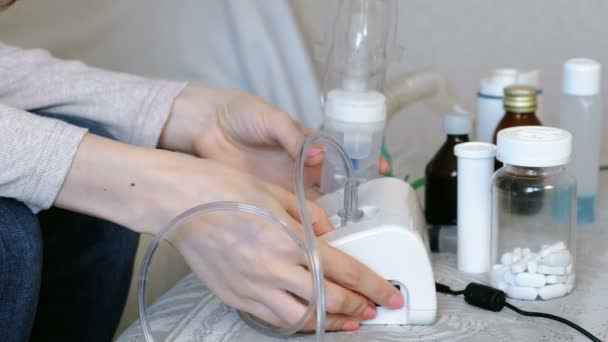 Use nebulizer and inhaler for the treatment. Closeup womans hands takes inhaler mask. Side view — Stock Video