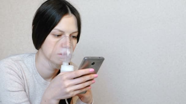 Vernevelaar en inhalator gebruiken voor de behandeling. Jonge vrouw inademen door inhalator masker. Zijaanzicht. — Stockvideo