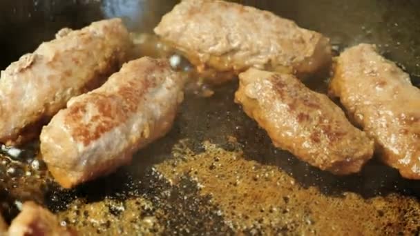 Le costolette di carne saporite sono fritte in olio in una pentola. Vista dall'alto in primo piano . — Video Stock