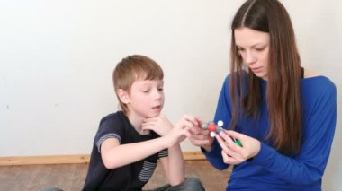 Anne oğluyla molekül modelleri renkli plastik inşaat bina ayarla.