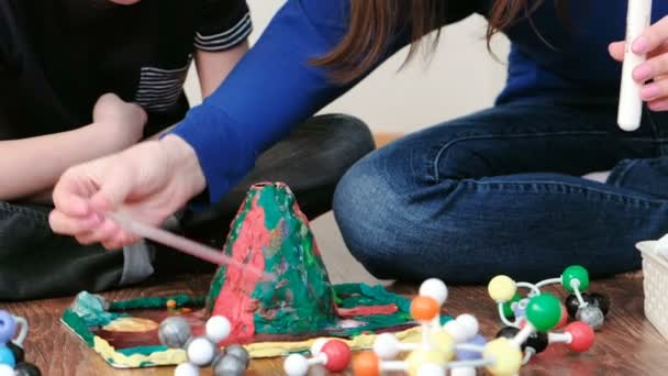 L'expérience de près avec le volcan de plasticine éclate mousse à la maison. Réaction chimique avec émission de gaz. Vue latérale . — Video