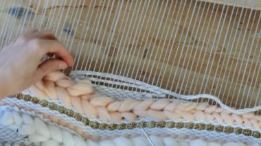 Tezgâh üzerinde dokuma. Tezgâh üzerinde çalışan kadının eller. İpliklerini iğne threading çerçeve ve tarak ile iplik bağlayın, tarak.