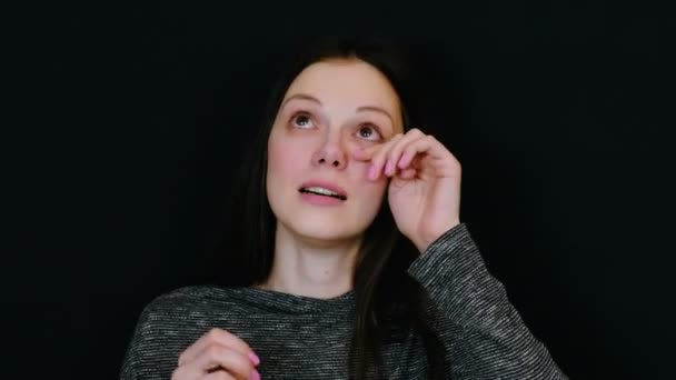 Close-up van vrouw lachen naar tranen gezicht op zwarte achtergrond. — Stockvideo