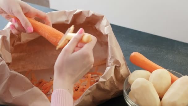 Closeup womans hands peeling carrot. — Stock Video