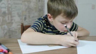 Çizgili tişört, 7 yaşında çocuk bir kalem ve bir cetvel ile kağıt üzerinde bile çizgiler çizer.