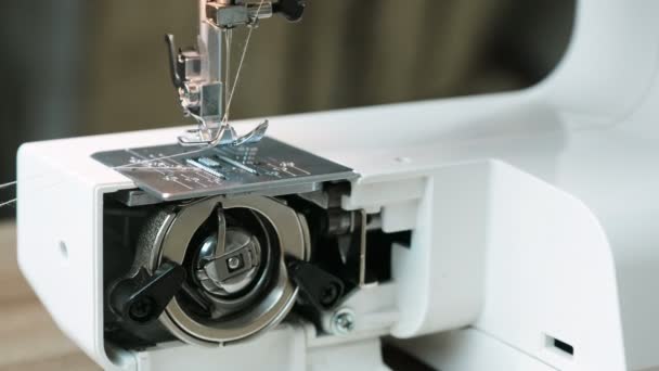 Close-up operation of the sewing machine from the inside with the lid open. Front view. — Stock Video