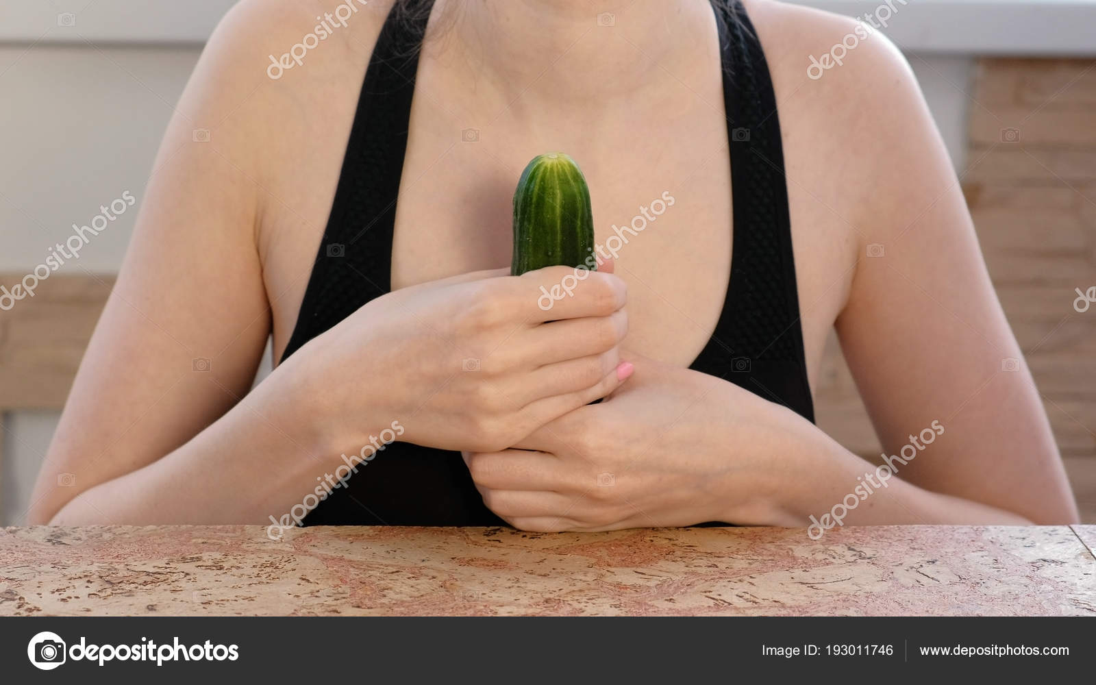 Woman hands holding cucumber and play with it