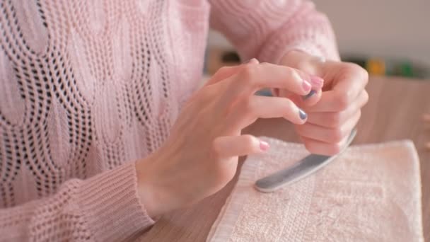 Woman puts the cream on the skin around the nails before removing the gel Polish. Hands close-up — Stock Video