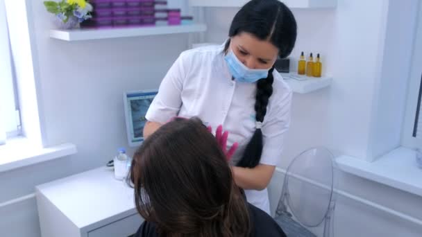 Врач трихолог делает инъекции мезотерапии в голове женщины, чтобы вылечить волосы . — стоковое видео
