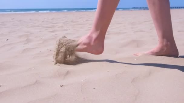 Woman walks barefooted on sand at sea beach resting on vacation, feet in sand. — Stock Video