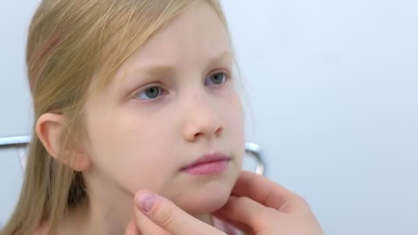 Pediatrician woman probing lymph nodes on neck of girl child during examination. — Stock Video