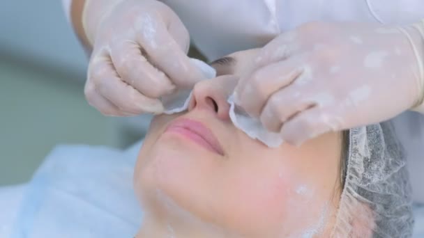 Καλλυντικά σκουπίζει μάσκα από το πρόσωπο των γυναικών χρησιμοποιώντας βαμβάκι μαξιλάρια στην κλινική ομορφιάς. — Αρχείο Βίντεο