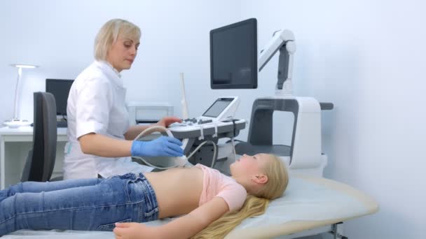 El médico está haciendo ultrasonido abdominal para niña usando escáner, vista lateral. — Vídeos de Stock