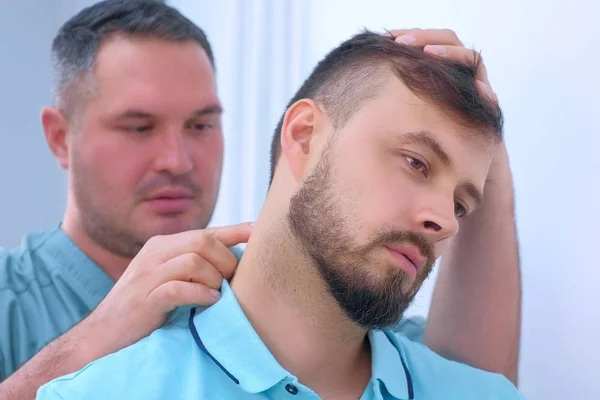 Man on preventive examination of doctor chiropractor on neck diagnostic. — Stock Photo, Image