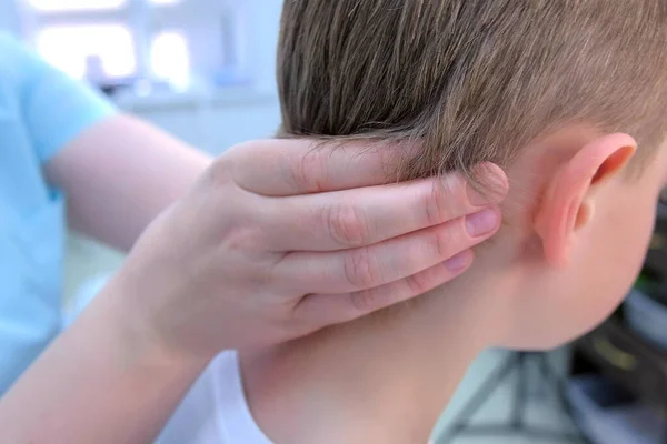 Doctor professional massagist makes head massage to teen boy in clinic, closeup. — 스톡 사진