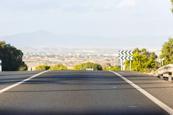 Receding into the distance, empty road in the mountains, summer.