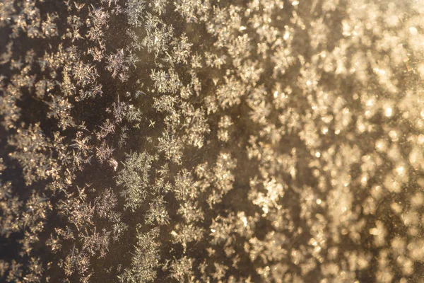 Little frosty patterns on glass, visible snowflakes. Winter in R — Stock Photo, Image