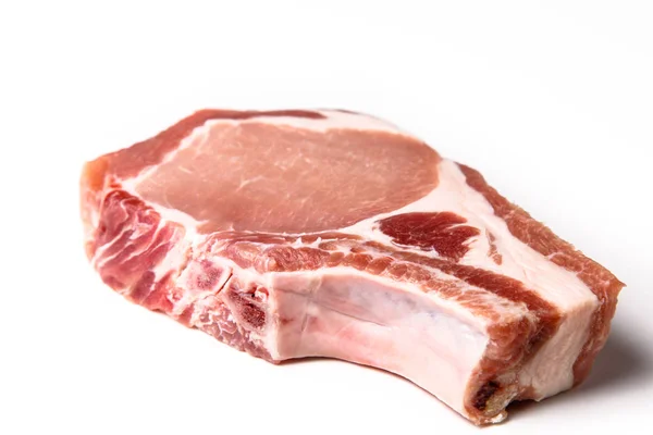 Raw pork loin on the bone is cut into steaks  a white backgrou — Stock Photo, Image