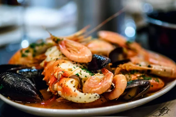 Shrimp, crayfish and mussels are on the big dish in the sauce.