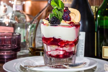 Bir tatlı taze yoğurt, reçel ve bir bardak taze çilek.