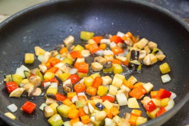 Küçük küpler halinde kesilmiş ve bir tavada kızarmış sebze.