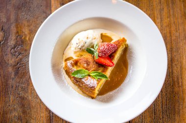 Bir parçası cheesecake taze çilek, nane ve bir kaşık ile 