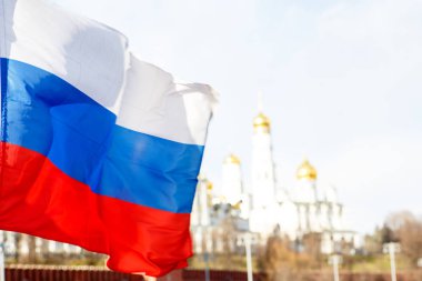 Russian flag on the background of the Moscow Kremlin clipart