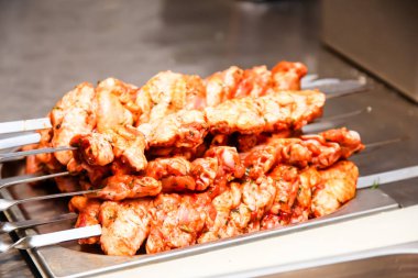 Tavuk parçaları şiş kebap pişirmek için bir şiş koymak.