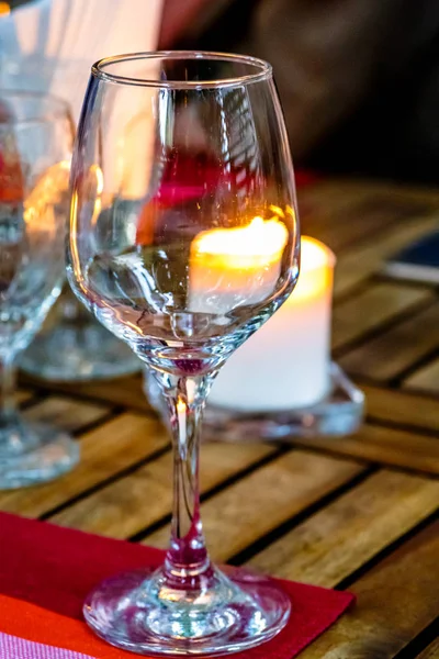 Copos de vinho e uma vela acesa na mesa, à noite . — Fotografia de Stock