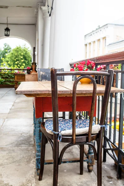 Old wooden table and chairs on the terrace. — Stock Photo, Image
