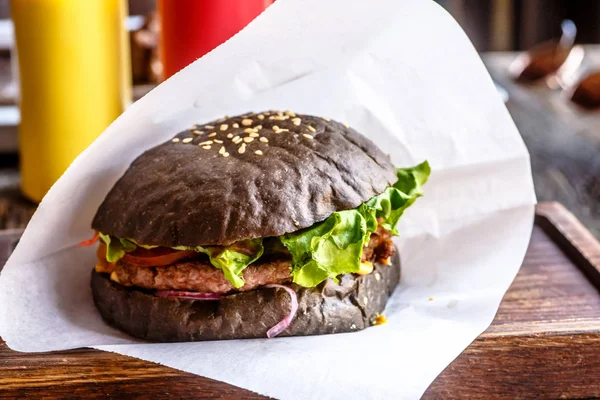 Black Burger is on the paper — Stock Photo, Image