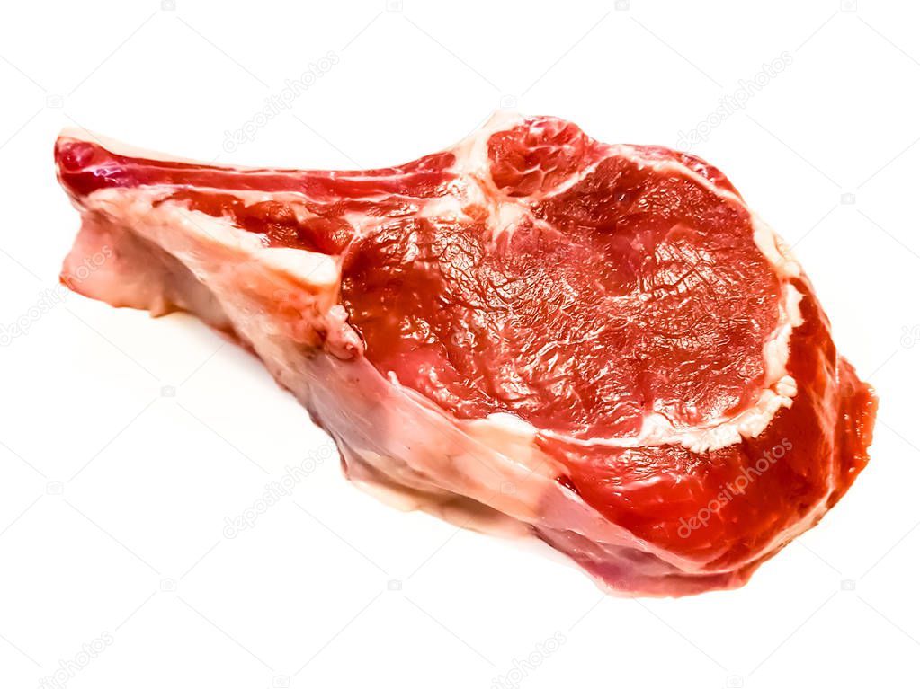 Rib eye on the bone or cowboy steak of beef or veal on a white b