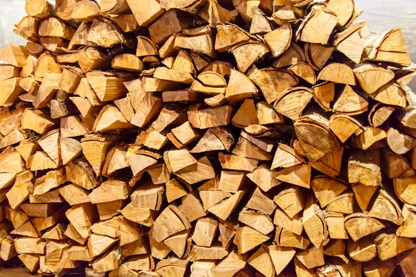 Birch logs for the fireplace are stacked against the wall. — Stock Photo, Image