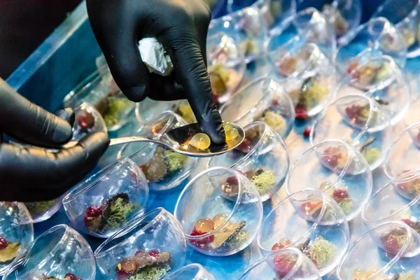 Molecular gastronomy, a chef decorates a dish of caviar