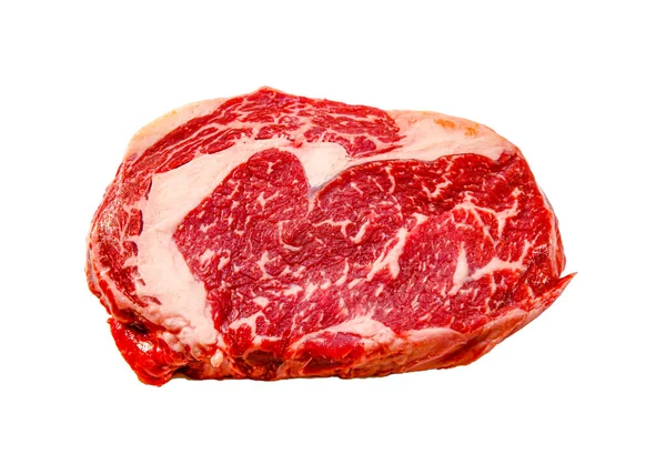 A rib eye steak of marbled grain-fed beef lies on a white backgr — Stock Photo, Image