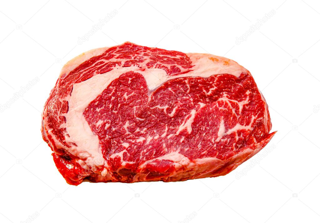 A rib eye steak of marbled grain-fed beef lies on a white backgr