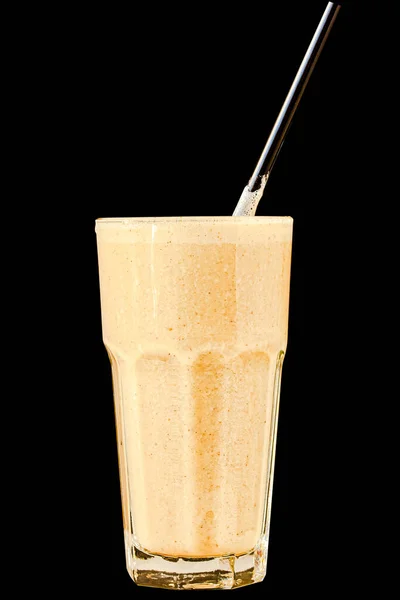 Brown Smoothie or cocktail with coffee and yogurt in a large glass glass on a black background, isolated.