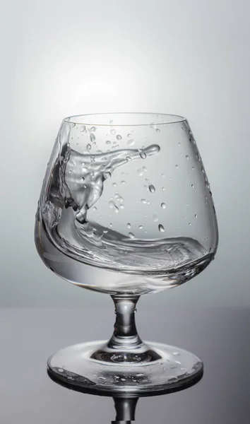 Liquid splash in a glass — Stock Photo, Image