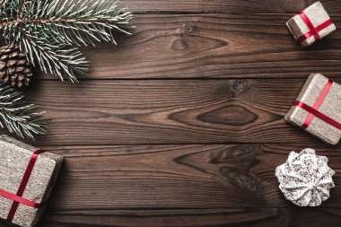 Kahverengi ahşap arka plan. Çam ağacı, dekoratif koni. Tatlılar. İleti alanına Noel ve yeni yıl için. Tatil için hediye.