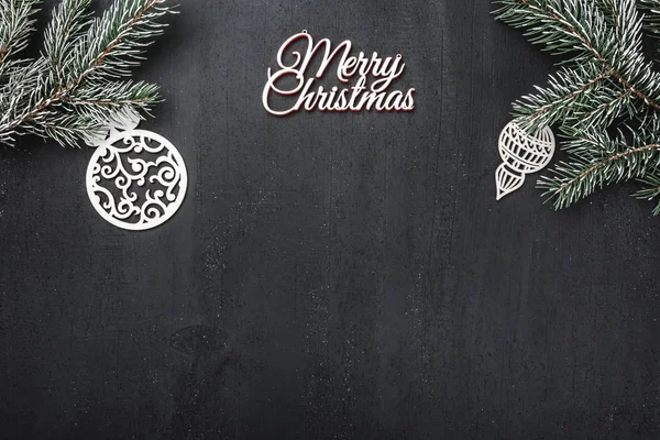 从上面看 手工木制玩具 常青树枝和白色快活的圣诞节题字在黑背景 与空间为文本文字 — 图库照片