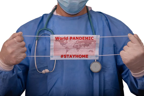 Doctor with biohazard protection clothing of Covid-19 contamination is holding a surgical mask on which the world map is drawn. Coronavirus world pandemic, Stay Home