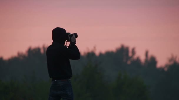 Cameraman faisant des photos de coucher de soleil vue sur le ciel — Video