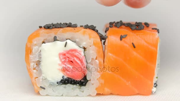 Chef presentation of luxury japan restaurant sushi rolls Otary maki with fresh raw salmon, cheese ginger pink and tobiko caviar rotating on white — Stock Video