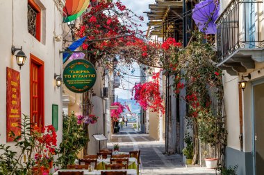 NAFPLIO, GREECE - MAY 10, 2017: outside traditional tavern restaurant, pedestrian street in central Nafplio, Peloponnese, Greece clipart