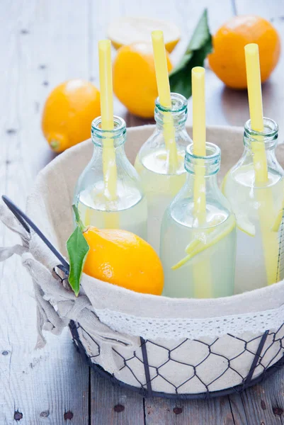 Basket lemonade bottles — Stock Photo, Image